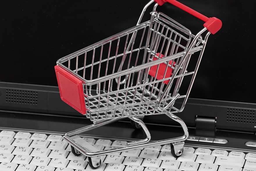 Shopping trolley on computer — buying online vs offline